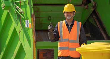 garbage-collector-happy-male-worker-with-dustbin-street-during-day